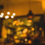 Defocused view of warm ambient lighting in a cozy café interior, perfect for a relaxing evening atmosphere.
